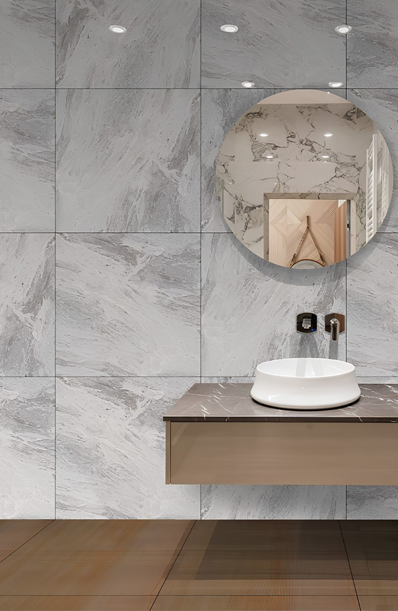 Baño con revestimiento cerámico gris y lavamanos de Cerámica COBOCE